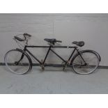 A vintage tandem bicycle with sprung seats