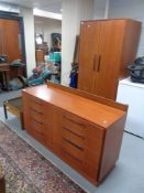 A 20th century teak G Plan double door wardrobe with matching Fresco eight drawer block chest,