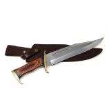 A bowie knife with brass mounted hilt,