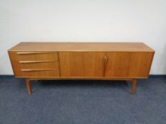 A 20th century McIntosh teak low sideboard fitted double door cupboards and three drawers