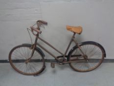 A vintage lady's bicycle with sprung seat