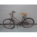 A vintage lady's bicycle with sprung seat