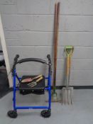 A Drive mobility walking aid together with a small quantity of garden tools