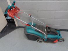 A Bosch electric lawn mower with grass box and lead
