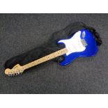 A Fender Squier stratocaster electric guitar in carry bag