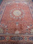 A machine made fringed woolen Persian design carpet on red ground,