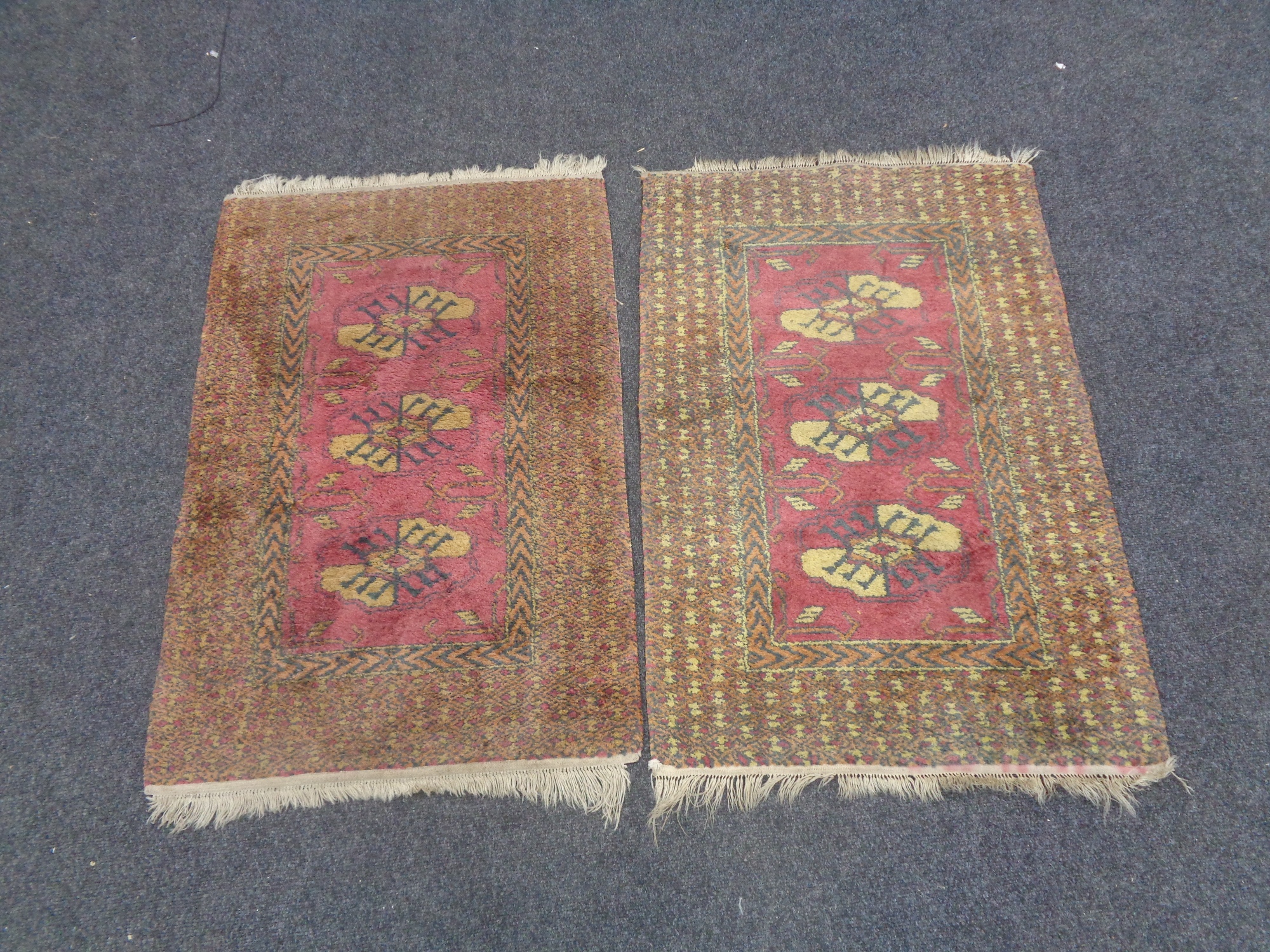 A pair of fringed woollen rugs of geometric design