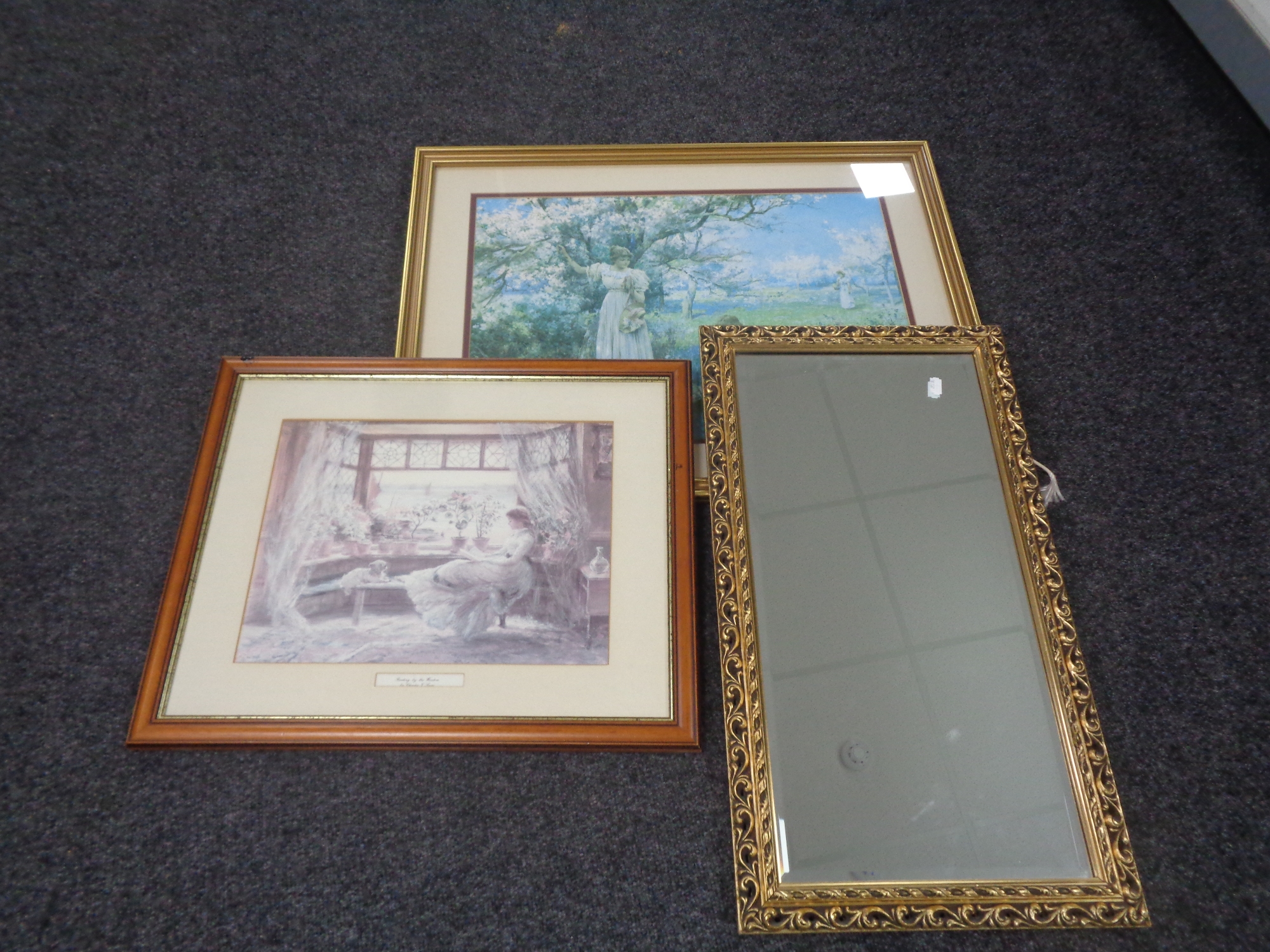 A gilt framed bevelled mirror together with two further framed prints