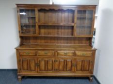 A good quality Victorian style oak dresser fitted four cupboards and four drawer beneath