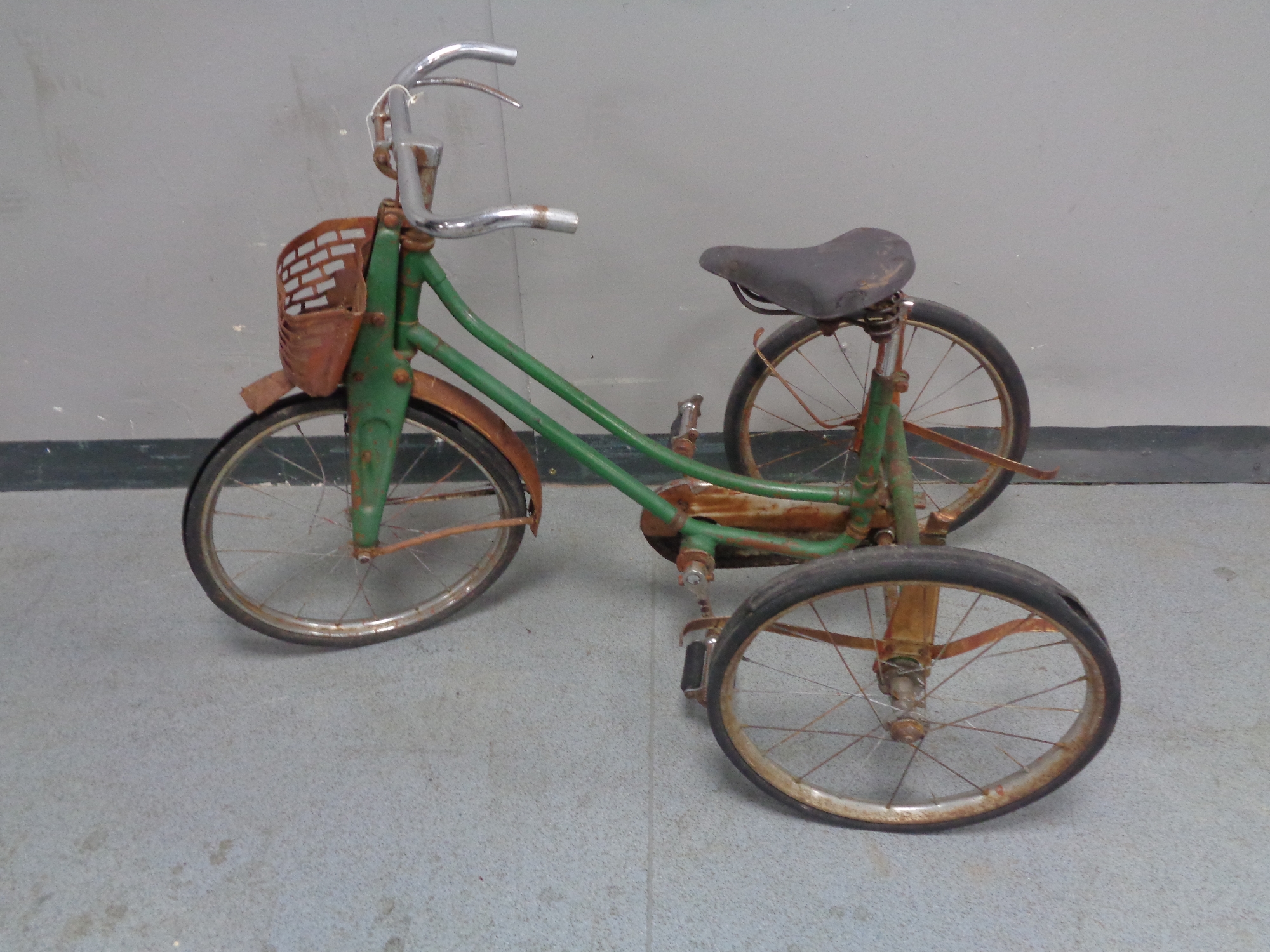 A 20th century child's tricycle with sprung seat