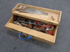 A mid 20th century joiner's toolbox containing assorted tools to include hand saws,
