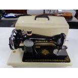 A cased Singer hand sewing machine