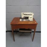 A mid 20th century Singer sewing machine in table