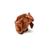 A carved Chinese hardwood netsuke - Rat holding corn