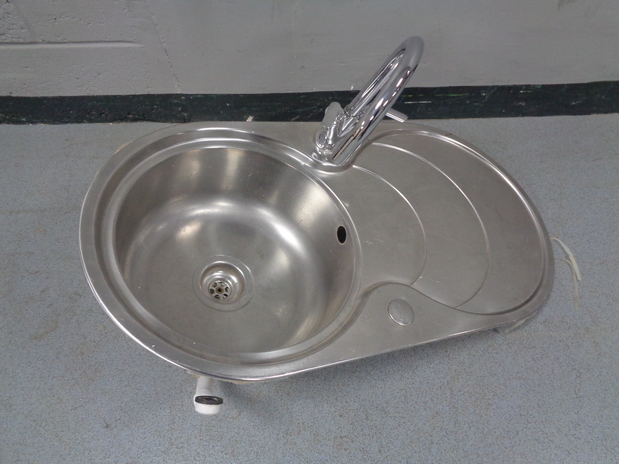 A stainless steel sink and drainer with mixer tap