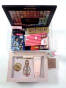 A tray containing assorted cosmetics, perfumes,