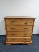 A pine four drawer chest with brass drop handles
