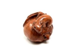 A carved Chinese hardwood netsuke - Two rats on fruit