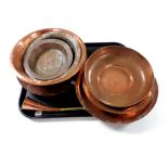 A tray of antique copper wares : eight dishes and plates,