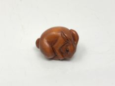 A carved Chinese hardwood netsuke - Rabbit feeding