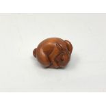 A carved Chinese hardwood netsuke - Rabbit feeding