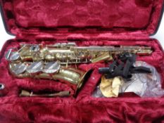 A cased brass Corton saxophone