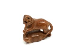 A carved Chinese hardwood netsuke - Tiger