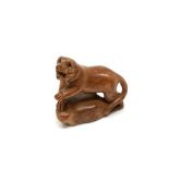 A carved Chinese hardwood netsuke - Tiger