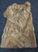 A fox fur coat with matching gloves and hat