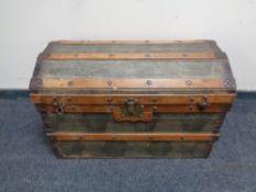 An early 20th century bound domed topped shipping trunk