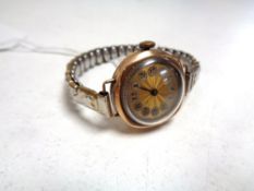 A lady's 9ct gold wristwatch on plated bracelet strap