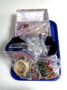 A tray containing a quantity of assorted costume jewellery to include beaded necklaces, bangles,