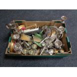 A box of early 20th century plated candelabra, egg cups on stands, plated cutlery,