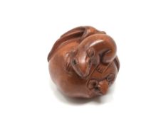 A carved Chinese hardwood netsuke - Two rats on fruit