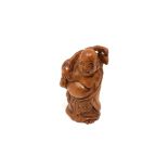 A carved Chinese hardwood netsuke - Village elder holding a sack