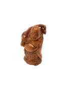 A carved Chinese hardwood netsuke - Village elder holding a sack