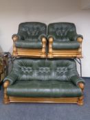 A wood framed green button leather three piece lounge suite