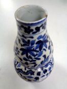 A Chinese porcelain blue and white double gourd-shaped vase depicting flowers and dragons,