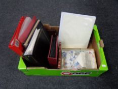 A box containing folders and albums containing 20th century world stamps together with a large