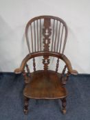 An antique elm kitchen Windsor armchair