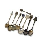 Eight silver spoons, some enamel examples.