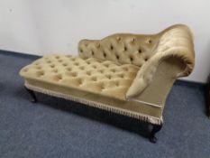 A chaise longue upholstered in gold fabric