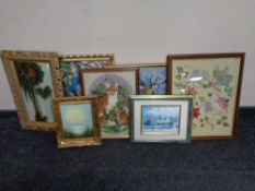 A box containing a framed needlework panel together with three further woolwork panels,