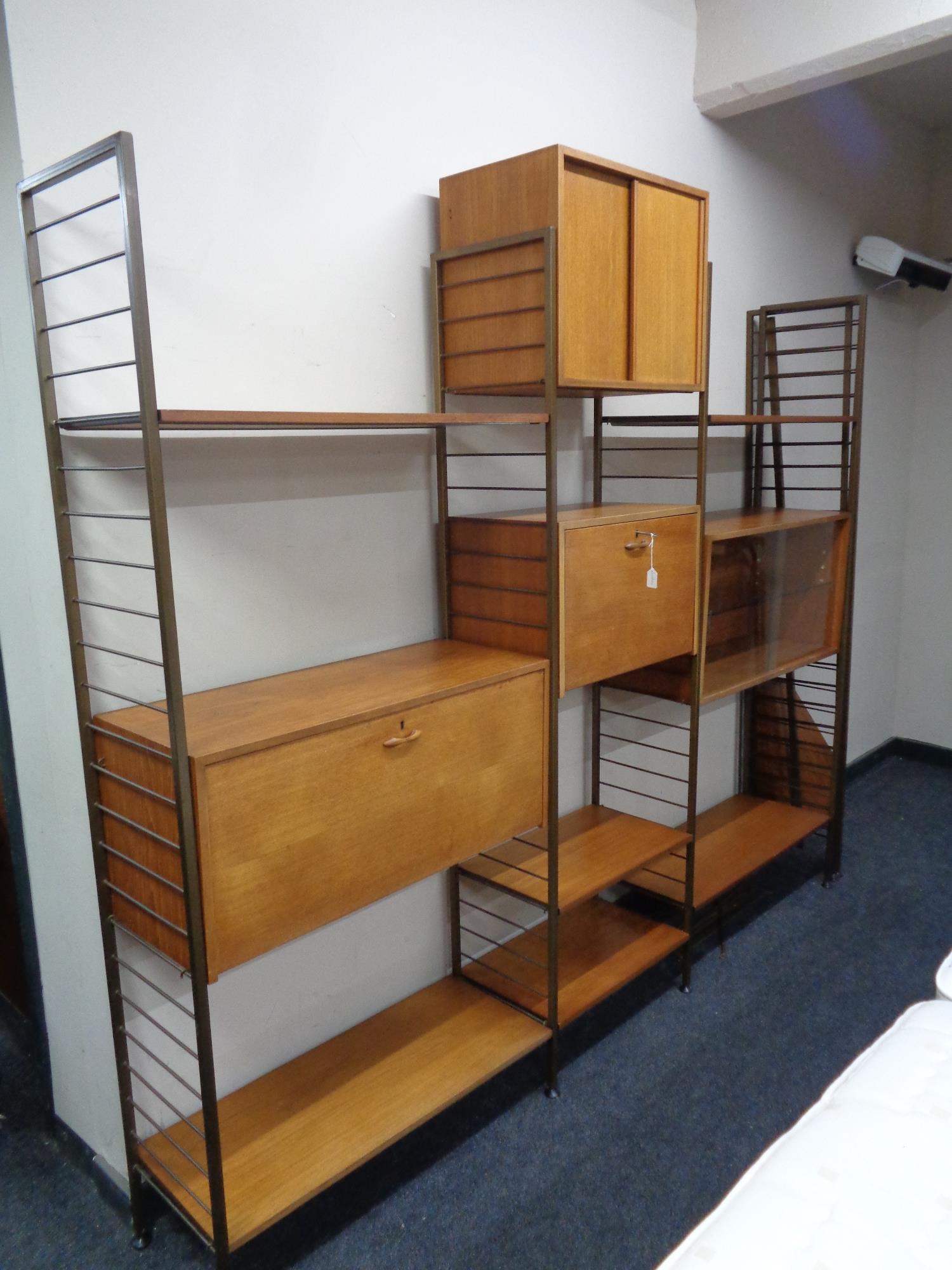 A mid 20th century Staples Ladderax three bay modular shelving unit together with matching four