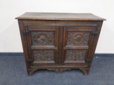 A 19th century carved oak double door cabinet