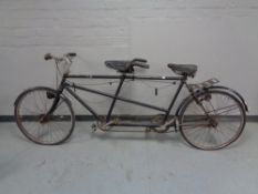 A vintage tandem bicycle with sprung seats