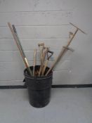 A bin containing a large quantity of assorted garden tools