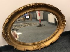 An antique bevel oval gilt framed mirror,