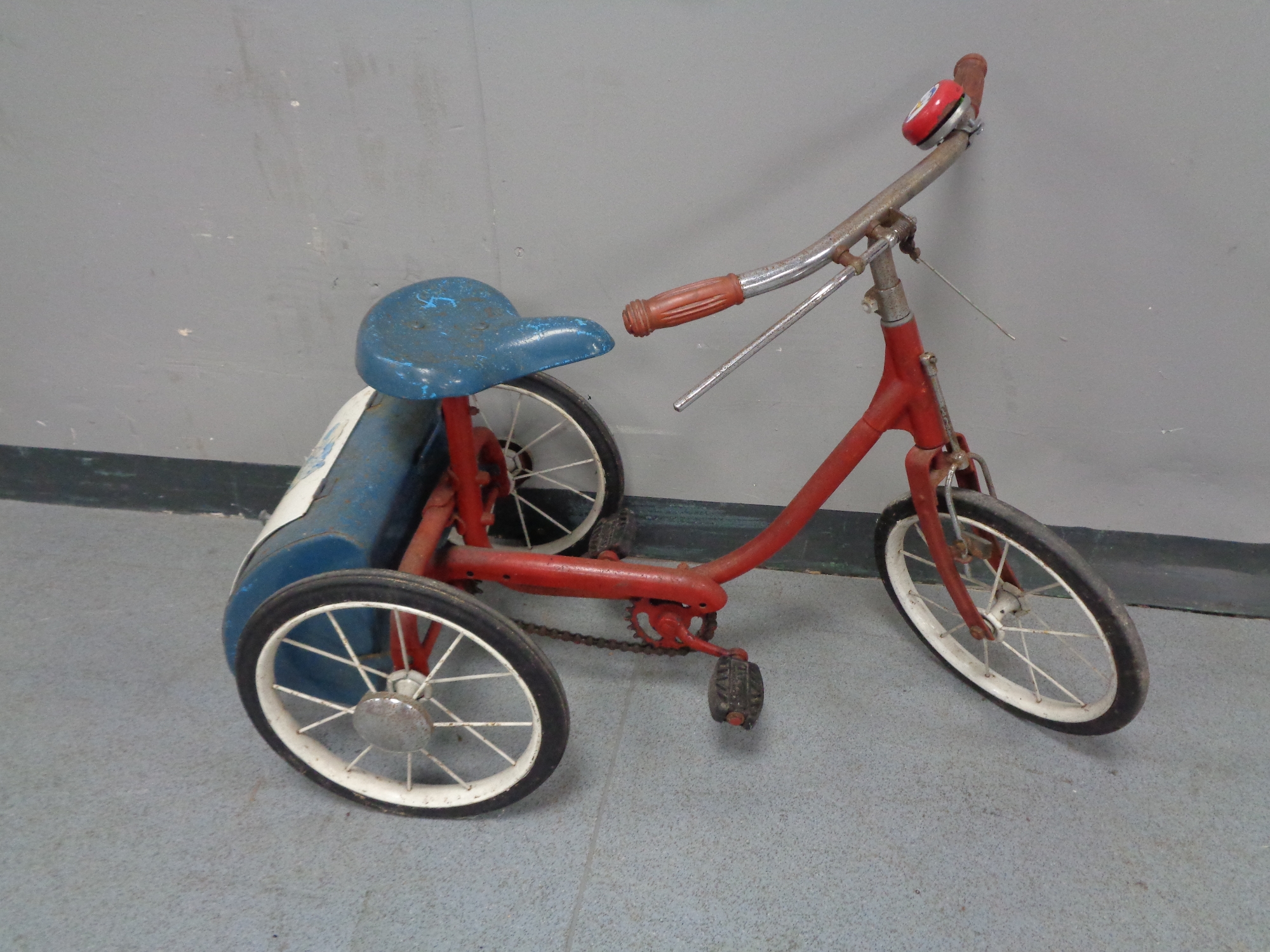 A 20th century child's tricycle with rear storage box