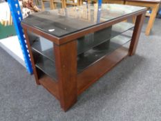 A contemporary black glass and wood framed TV stand